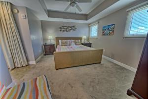a large bedroom with a bed and a ceiling fan at PierPark Cozy Condo w View Sterling Breeze Resorts in Panama City Beach +28 photos