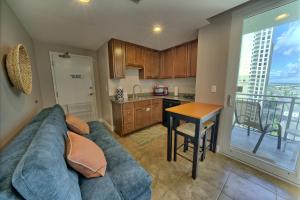 a living room with a couch and a table and a kitchen at PierPark Cozy Condo w View Sterling Breeze Resorts in Panama City Beach