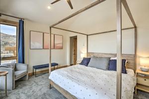 a bedroom with a canopy bed and a chair at Luxe Home with Patio and Pool Access in Silverthorne! in Silverthorne