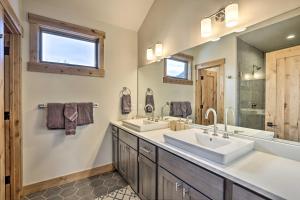 a bathroom with two sinks and a large mirror at Luxe Home with Patio and Pool Access in Silverthorne! in Silverthorne +37 photos