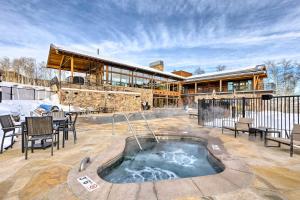 a house with a hot tub on a patio at Luxe Home with Patio and Pool Access in Silverthorne! in Silverthorne