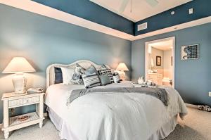 a bedroom with a white bed with blue walls at Waterfront Chesapeake Bay Condo with Boat Slip! in Crisfield +26 photos