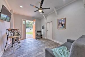 a living room with a couch and a ceiling fan at Cozy Jacksonville Studio - 10 Miles to Downtown! in Jacksonville