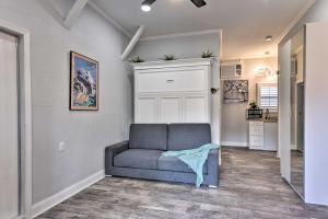 a living room with a couch and a kitchen at Cozy Jacksonville Studio - 10 Miles to Downtown! in Jacksonville