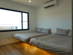 מיטה או מיטות בחדר ב-Summerflow Hostel
