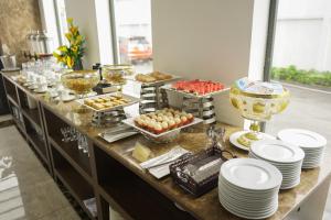 ein Buffet mit Tellern und Speisen auf dem Tisch in der Unterkunft ELIZABETH HOTEL in Thu Dau Mot