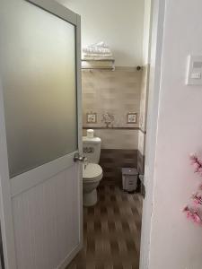 an open door to a bathroom with a toilet at Melody Homestay Quy Nhơn in Quy Nhon