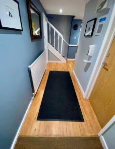 a hallway with a black rug on the floor at The Ferryboat in Fishguard