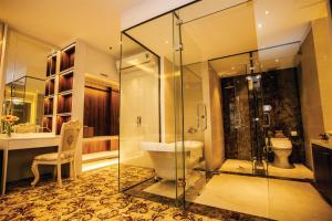 a bathroom with a glass shower and a toilet at ELIZABETH HOTEL in Thu Dau Mot