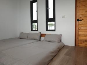 מיטה או מיטות בחדר ב-Summerflow Hostel