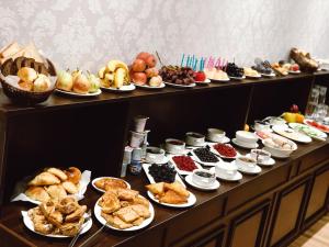 a buffet filled with different types of food on plates at Alliance Hotel Tashkent in Tashkent