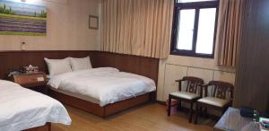 Säng eller sängar i ett rum på Jin Ge hot spring Hotel