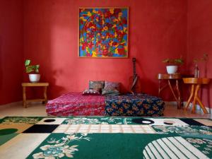 a bedroom with a bed and a painting on the wall at Azza karimunjawa in Karimunjawa +17 photos