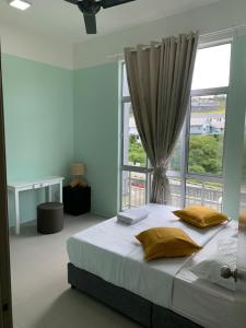 a bedroom with a large bed with a window at Play Residence at Golden Hills in Cameron Highlands