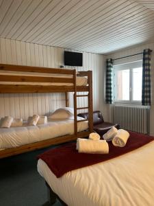 a bedroom with two bunk beds and a window at Relais Des Villards in Séez
