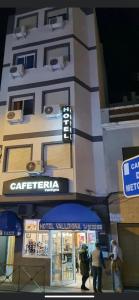 a tall building with a sign on the side of it at Hotel Valldigna in Tavernes de Valldigna