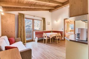 a living room with a couch and a table at Residence Schiestlhof in Natz-Schabs