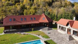 an aerial view of a house with a swimming pool at Darino in Rodnikovka