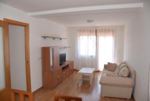 a living room with a couch and a tv at Apartamento en Alcora (Castellón) in Alcora