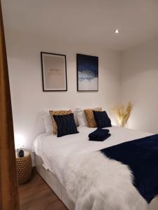 ein Schlafzimmer mit einem großen weißen Bett mit zwei Kissen in der Unterkunft Le petit Dubaï in Douai
