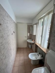 a bathroom with a sink and a toilet at SUITE DOLOMITI Appartamento in Falcade