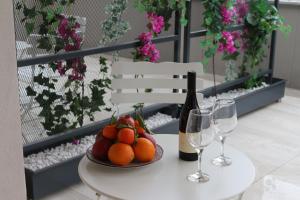 a table with a plate of fruit and a bottle of wine at FILEO ELEGANT LIVING in Veria