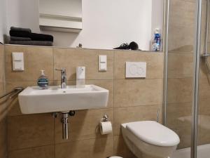 a bathroom with a sink and a toilet at Zentrum,Modern,Silently,New Property,Parking Place,Netflix in Wetzlar