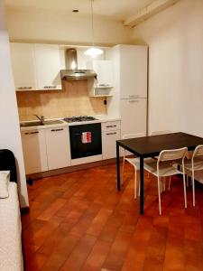 - une cuisine avec une table et des chaises dans la chambre dans l'établissement Il vicolo By Turistica, à Domodossola