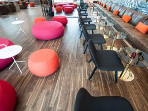 a row of chairs and tables in a room at Motel L Hammarby Sjöstad in Stockholm