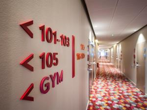a hallway in a hospital with a clock on the wall at Motel L Hammarby Sjöstad in Stockholm
