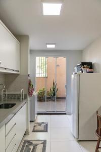 a kitchen with a stainless steel refrigerator in a room at Aconchego in Maringá +20 photos