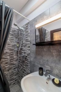 a bathroom with a shower and a white sink at Pensiunea Doro in Călimăneşti