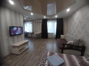 a living room with a couch and a tv at Apartment at Kirova (A.Polia) in Dnipro