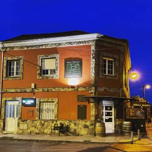a building with a sign on the side of it at Belmonte Rooms - check in Hotel a 650 metros in Gijón