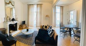 a living room with a couch and a table at les croix appartements in Morlaix