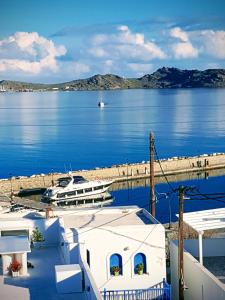 a boat is docked at a marina in the water at Flora Rooms & Apartments in Naousa