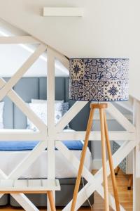 a lamp in a bedroom with a bunk bed at Villa Baixa - Lisbon Luxury Apartments in Lisbon