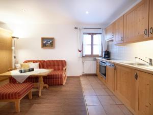 a kitchen and living room with a couch and a table at Gästehaus Bernhard in Krün