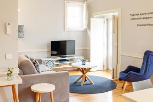 a living room filled with furniture and a tv at Villa Baixa - Lisbon Luxury Apartments in Lisbon