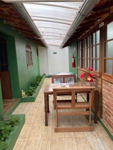 a patio with a wooden table and benches in a building at Pousada Pouso da Paz in Tiradentes +26 photos