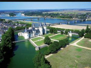 an aerial view of a castle in the middle of a river at Hotel La Tour in Sully-sur-Loire