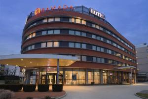 
a large building with a clock on the front of it at Hotel Ramada Graz in Premstätten
