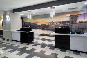 a lobby with a large painting on the wall at La Quinta by Wyndham Prattville in Prattville