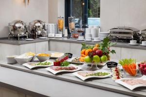 a buffet with fruits and vegetables on a table at 1 ART HOTEL in Moscow