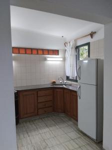 a kitchen with a white refrigerator and a sink at Doña Wilma in San Rafael