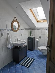 a bathroom with a sink and a toilet at Ferienwohnung "Am Wald" in Schmiedefeld am Rennsteig