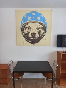 a black table with a picture of a bear wearing a hat at Apartament przy Stoku in Krynica Zdrój