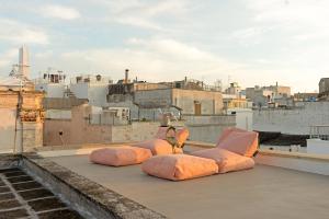 a group of pillows sitting on top of a roof at Eurydice Suite with Infinity Jacuzzi in Ostuni