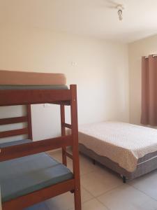 a small room with a bunk bed and a ladder at Chalés Airumã in Caraguatatuba