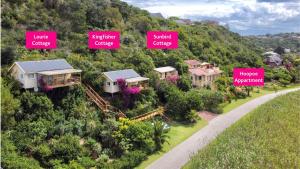 a group of houses on a hill with signs at JustFor2 in Wilderness